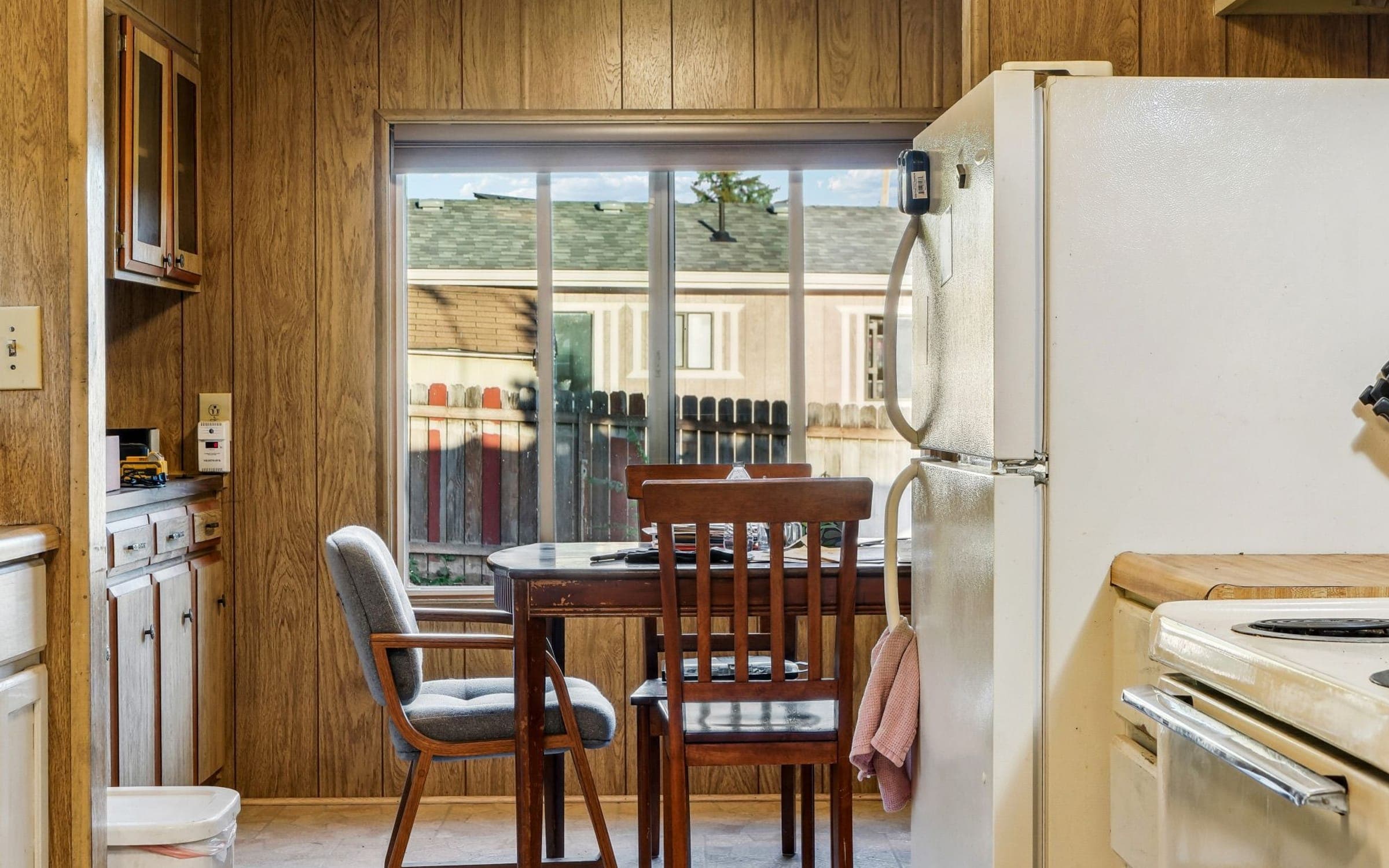 An ordinary lived-in kitchen with a dining table by the window